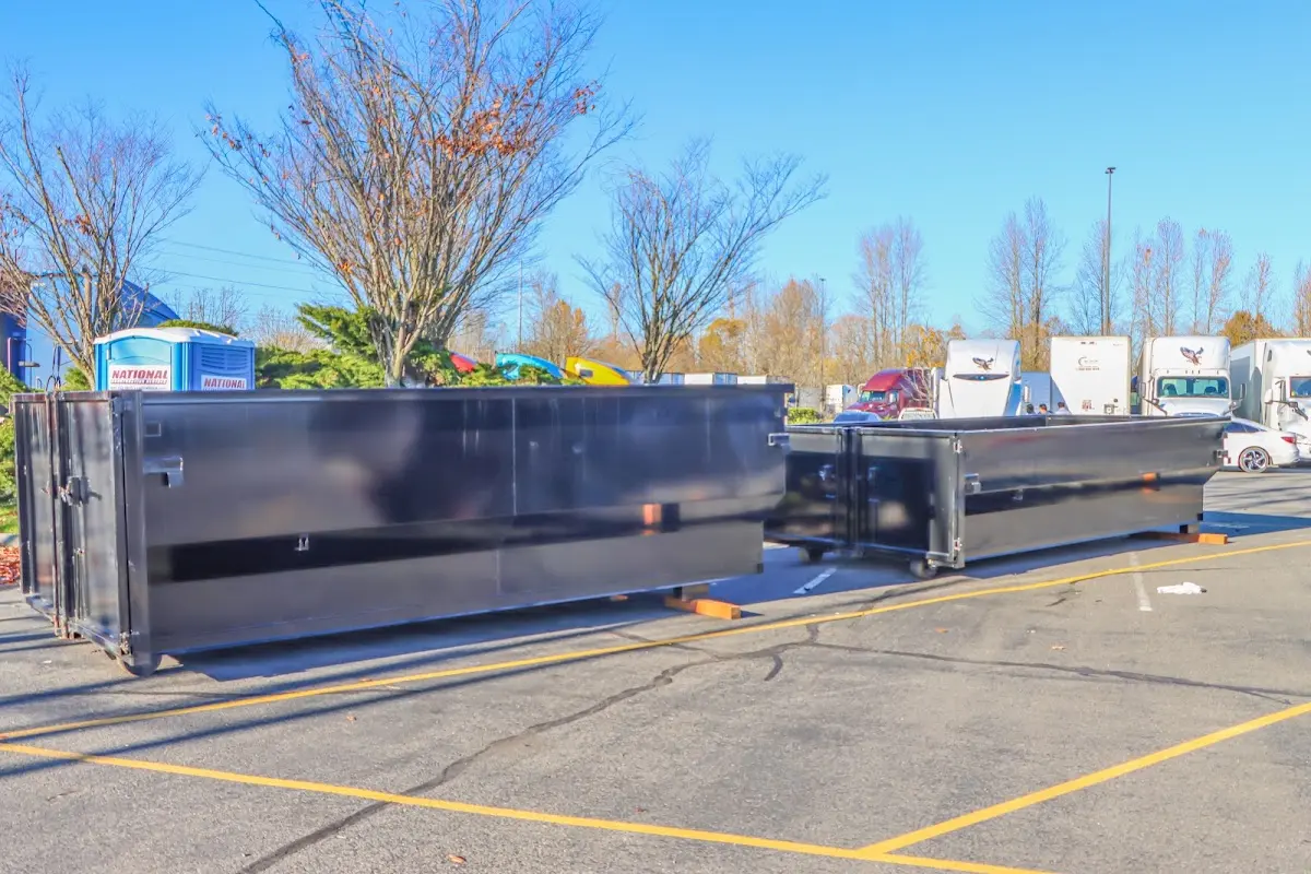 Professional dumpster rental service with roll-off container on residential driveway in Maricopa
